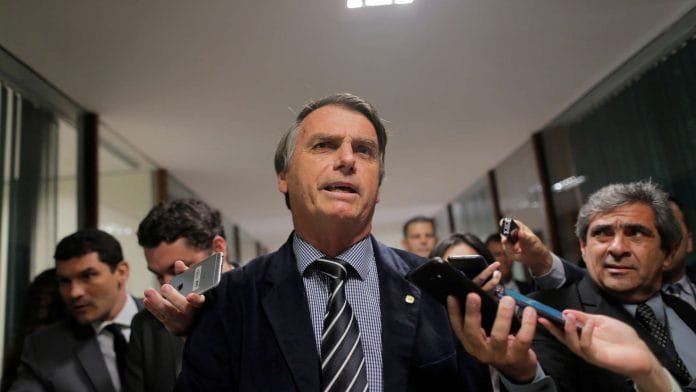 Presidential candidate Bolsonaro speaks with journalists at the National Congress in Brasilia