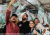 Jean Oliveira e Márcia Oliveira levam força da campanha aos bairros de Porto Velho Os candidatos Jean Oliveira e Márcia Oliveira sorriem e celebram com apoiadores durante uma grande reunião política em Porto Velho.