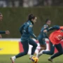 Seleção feminina faz estreia histórica no Beira-Rio contra a Argentina Jogadoras da seleção brasileira feminina durante um treinamento no gramado, vestindo uniformes azuis e laranjas com o escudo da CBF.