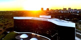 TSE mantém ordem para que Meta garanta isonomia entre candidatos presidenciais Vista aérea do edifício do Tribunal Superior Eleitoral (TSE) em Brasília, exibindo a sua arquitetura com fachada em curva negra e branca sob a luz de um pôr do sol.